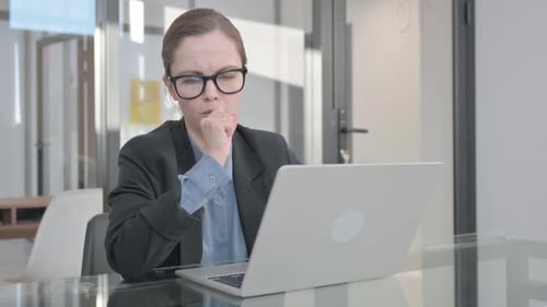 Woman Coughs While Working at Laptop