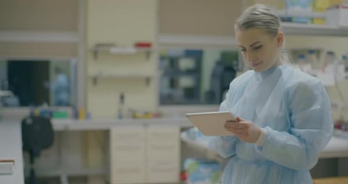 Female Scientist Using Digital Tablet in Lab Setting