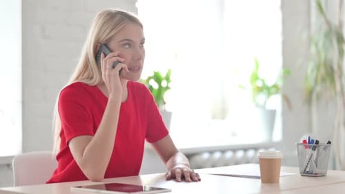 Woman Talking on Smartphone in Bright Office