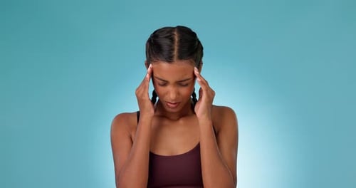 Headache, woman and pain in studio with stress, burnout or mental health