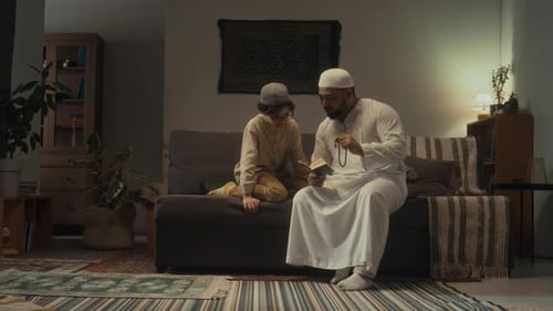 Father Reading Prayers from Koran with Rosary and Teaching Little Son