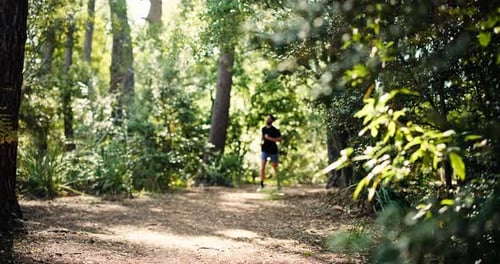 Athlete, man and running for fitness in forest with exercise, cardio training and morning routine
