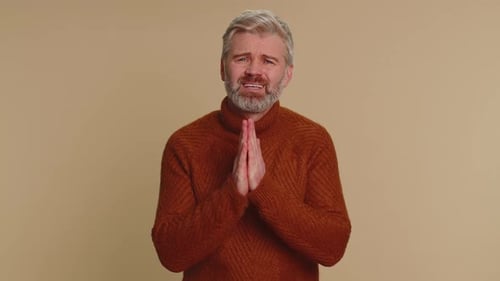 Man Clasping Hands, Hopeful Expression