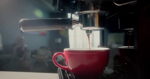 Pouring Coffee Stream From Machine in Red Cup Home Making Hot Espresso Using Filter Holder Flowing