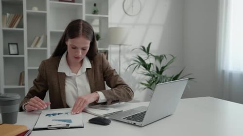 Beautiful Lady Office Worker Works with Schedules While Sitting at Home