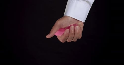 Hand Squeezes Pink Heart Paper