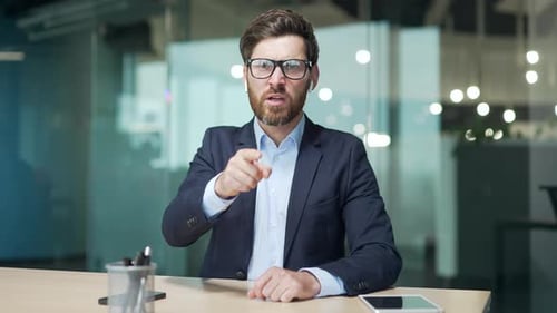 Webcam view of irritated arguing angry mature boss business man looking at the camera and yelling