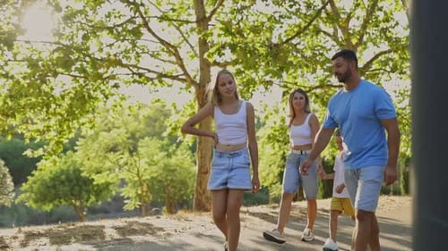 Family Enjoying a Walk Together in a Park