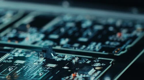Close-up Macro Shot of Electronic Factory Machine at Work: Printed Circuit Board Being Assembled wi