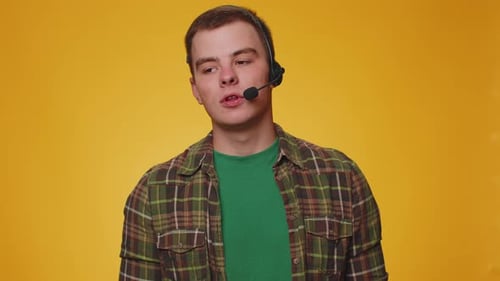 Young Man Freelance Worker Call Center or Support Service Operator Helpline Having Talk with Client