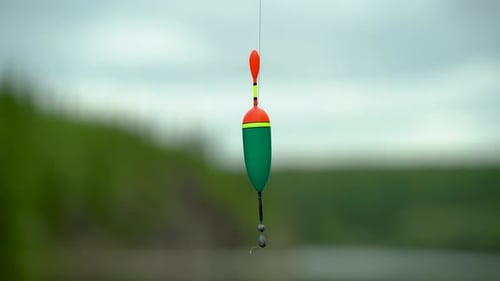 Close Up Of A Float With A Weight On A Fishing Line