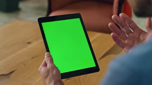 Man Holding Tablet with Green Screen for Compositing