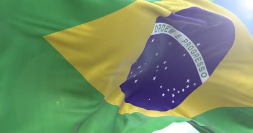 Brazil National Flag Waving Loop Against Blue Sky