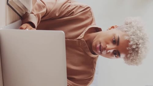 Young Adult Relaxing with Laptop Computer at Home