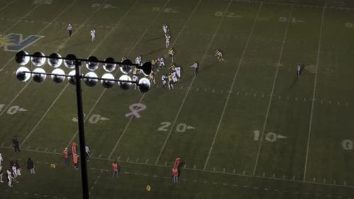 American Football Teams of Play Game at Night Time Drone Shot