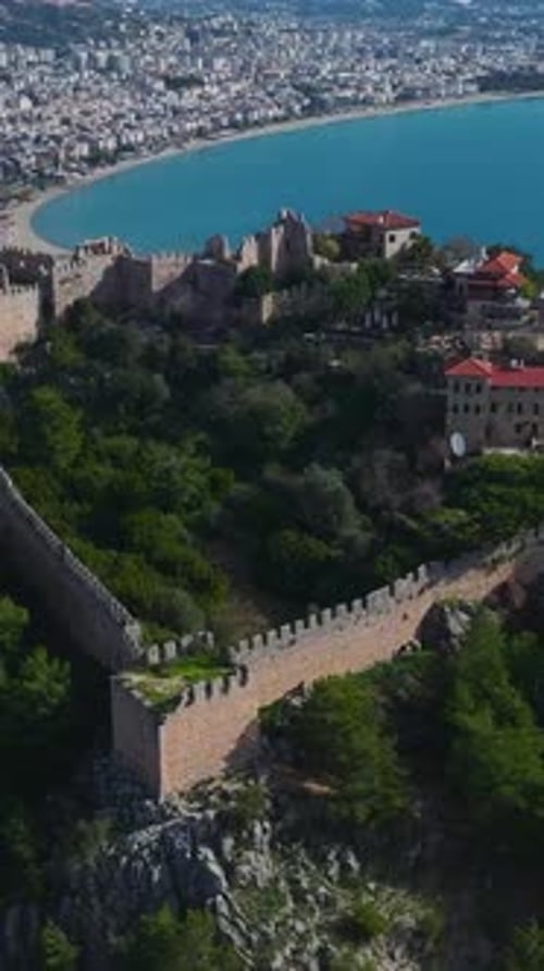 Aerial Video of a Mountain Fortress in Alanya With Thick Stone Walls a Green Park and a Stunning