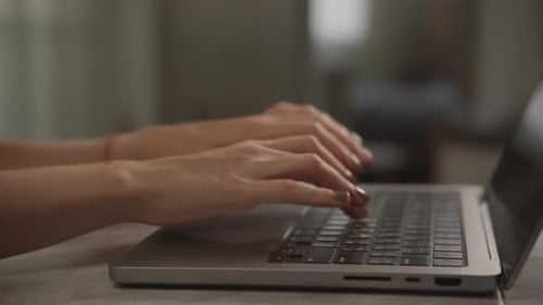 Woman's Hands Typing on Laptop Computer at Home