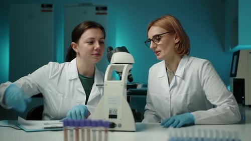 Scientists Conducting Research in a Lab Using Microscope