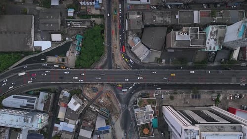 Aerial View From Above of Busy Urban Traffic Driving on Highway Overpass and Intersecting Roads in