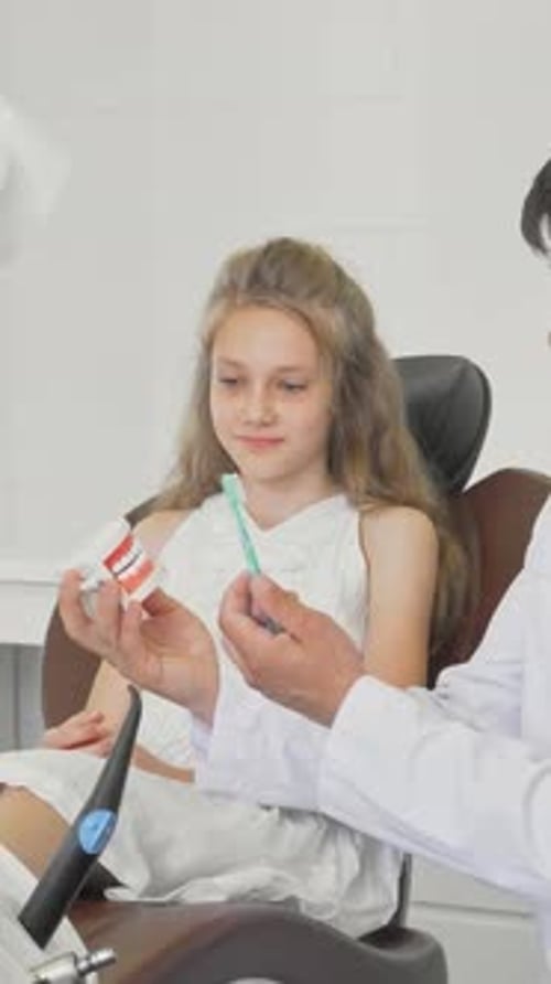 Dentist Shows Girl How to Brush Teeth Model
