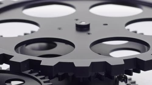 Gray Mechanical Gears Rotating Abstractly on White