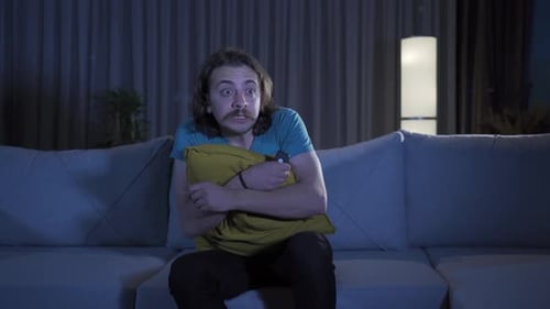 The man who watches horror and thriller movies or documentaries at night gets scared.