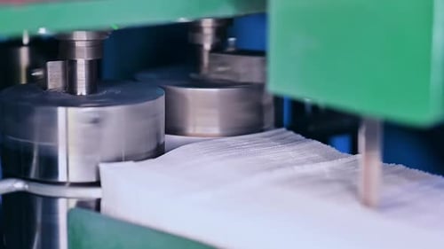 Machinery Producing White Tissues in Factory Setting