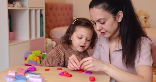 Mother and Daughter Play with Colorful Modeling Clay