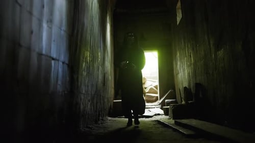 Masked Figure Walks Down Dark Hallway