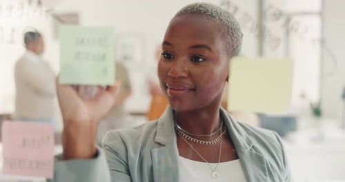 Creative, idea or black woman writing on sticky note planning agenda, marketing strategy
