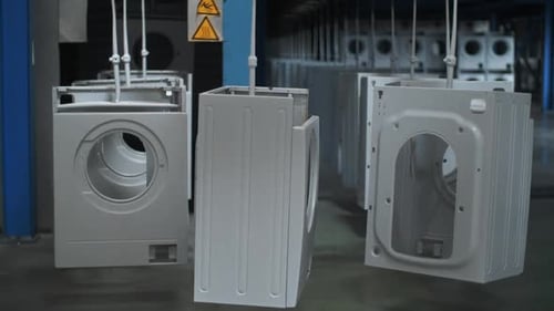 Washing Machine Carcase Moving On Automatical Conveyor At Modern Factory. White Laundry Machine O...