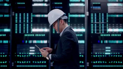 Side View of Asian Businessman Use Tablet While Walking in Data Center