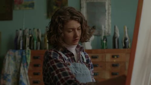 Young Female Artist Painting in Art Workshop Close Up