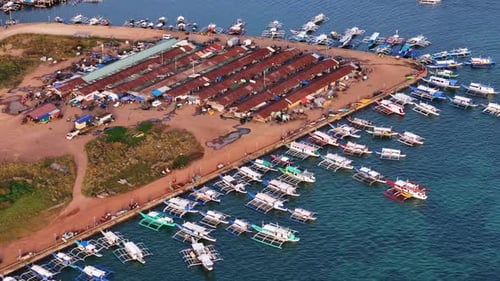 Stunning drone shot of Coron Port, showcasing the bustling harbor and crystal-clear waters.