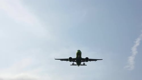 passenger airplane of a commercial flight flies overhead near the airport
