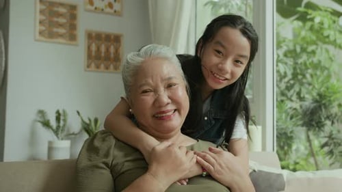 Loving Granddaughter Hugging Grandmother Smiling