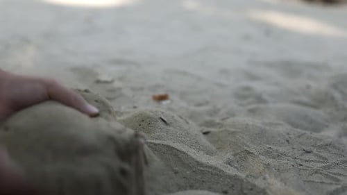 Girl child playing in the sand. Playing with sand in the park.
