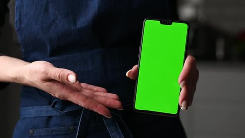 Girl In Apron Holding In Hands Greenscreen Chroma Key Smartphone