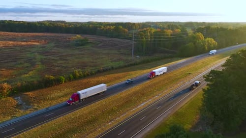 Aerial View of Busy American Freeway with Fast Moving Cars and Trucks Interstate Hauling of Goods