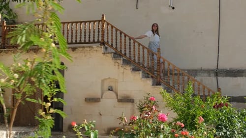 Woman Descending Stairs on Building Exterior in Daytime