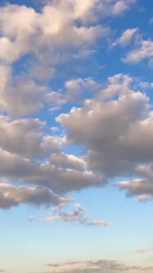 White Clouds Drifting Across Blue Sky