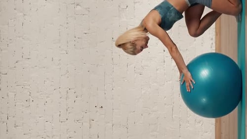 Woman Does Handstand Against Brick Wall