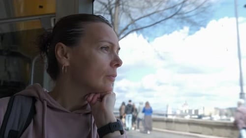 Woman Gazing Out Window During City Ride