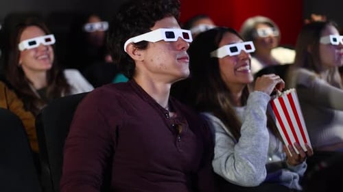 Enthusiastic Moviegoers Enjoying 3D Film at Cinema