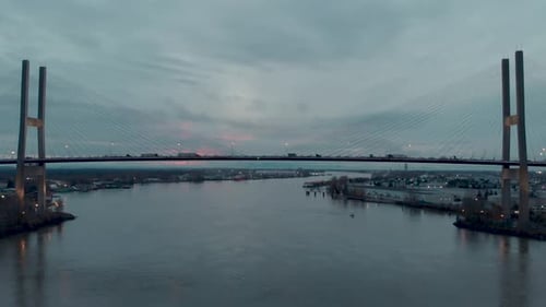 Drone 4K Footage Alex Fraser Bridge forward flight towards suspension bridge span while cars and tru