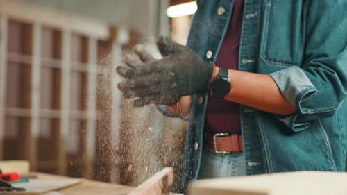 Dust, carpenter and hands of person in workshop for construction worker, woodwork and furniture