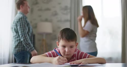 Un hijo se siente frustrado mientras sus padres se pelean en segundo plano