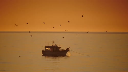 Fishing Boat on Sea at Sunrise