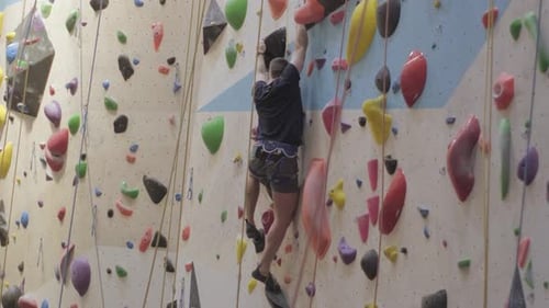 Young Adult Climbing an Indoor Climbing Wall