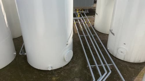 Elevated Vantage Point: Gas, Diesel, and Petroleum Tank Farm with White Steel Storage